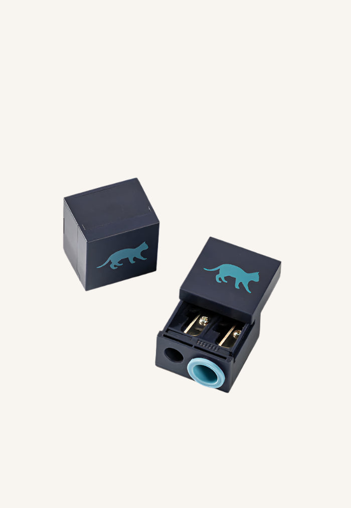 A black and blue dual size crayon sharpener with a cat silhouette design on the side.