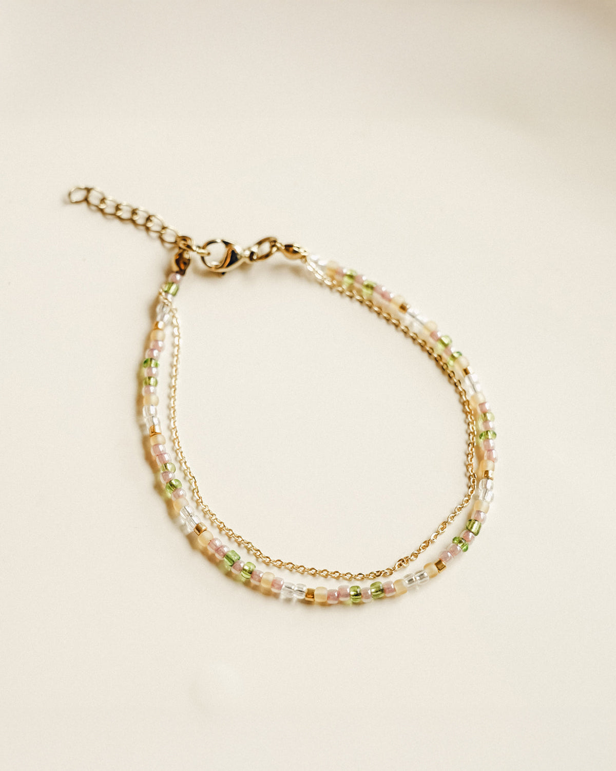 handmade beaded bracelet layered with dainty gold-plated chain
