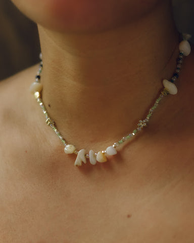 Model wearing the Envet Matcha Babe Necklace, a 15-inch green beaded necklace with shell accents and gold-plated chain