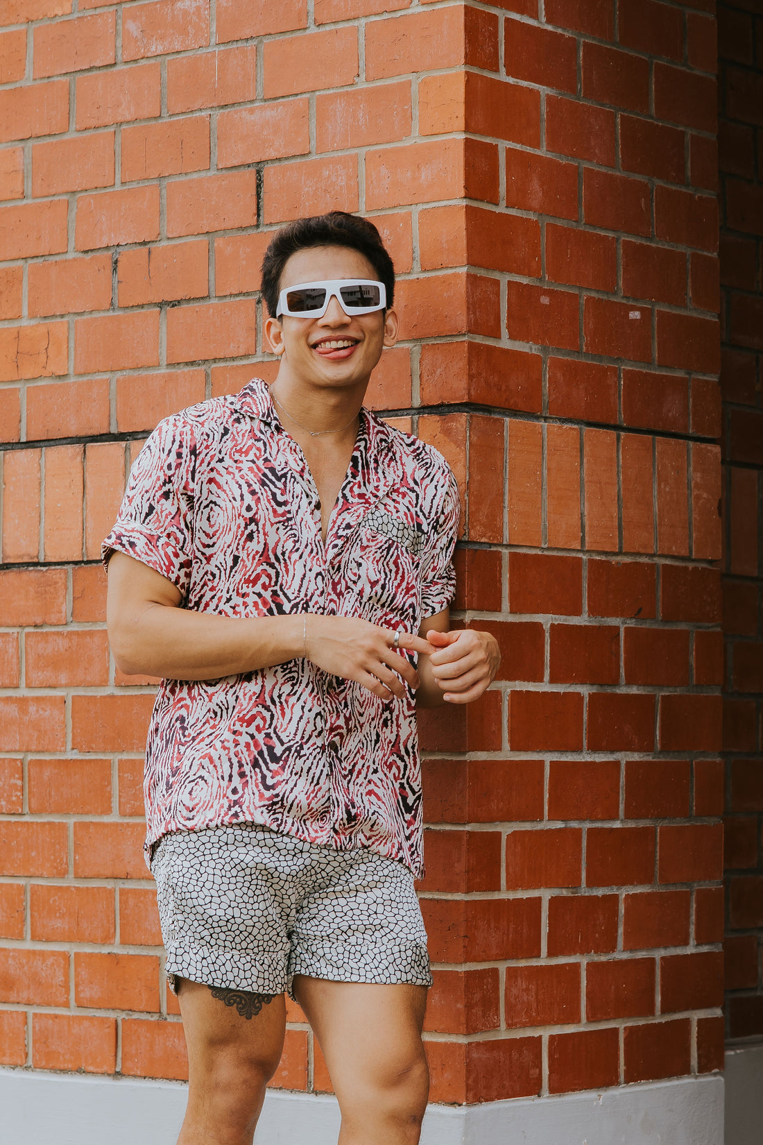 Model wearing Raja Rani Soft Pink Animalier Holiday Set featuring a pink animalier print shirt and matching shorts.