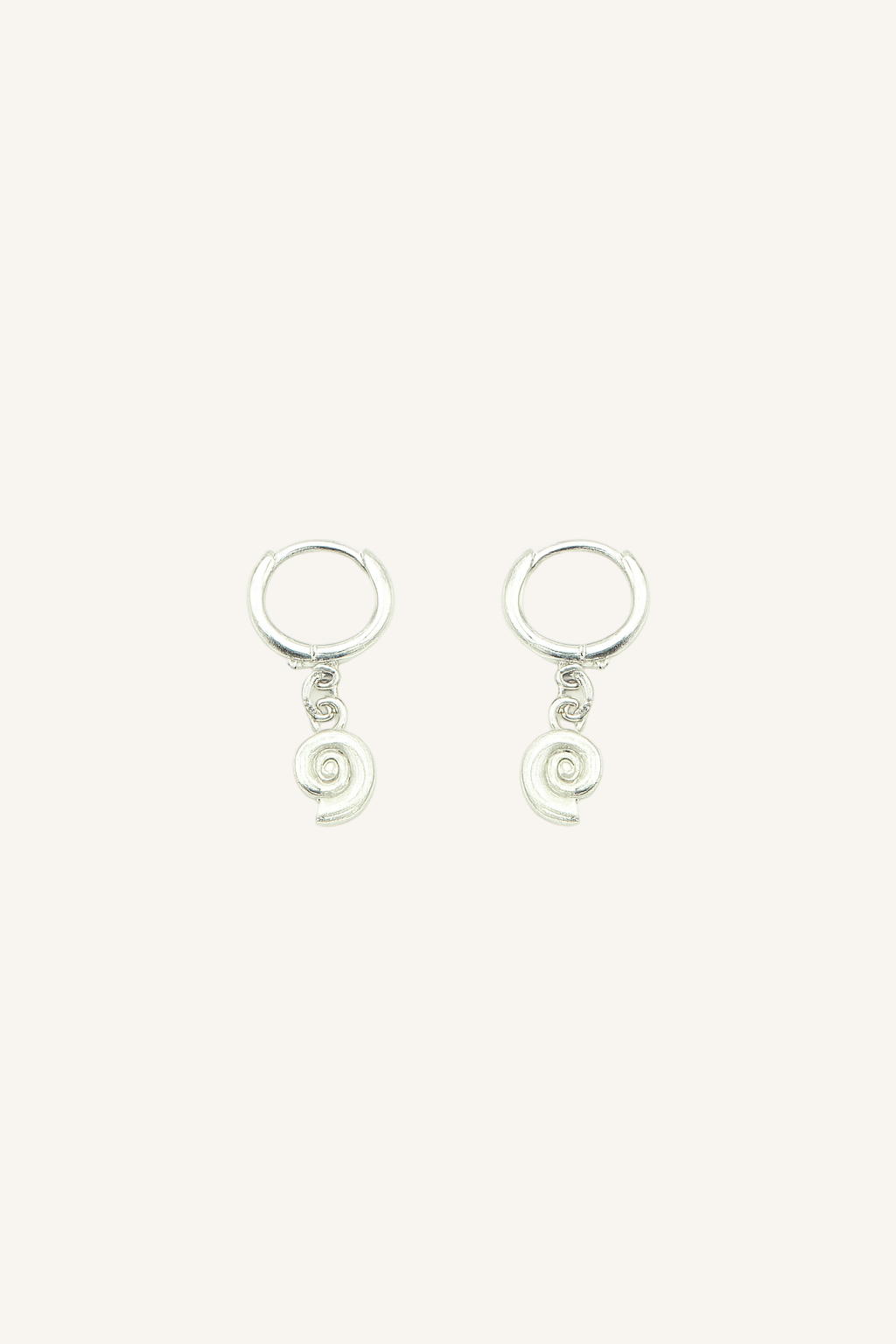 Pair of silver spiral conch earrings on a white background