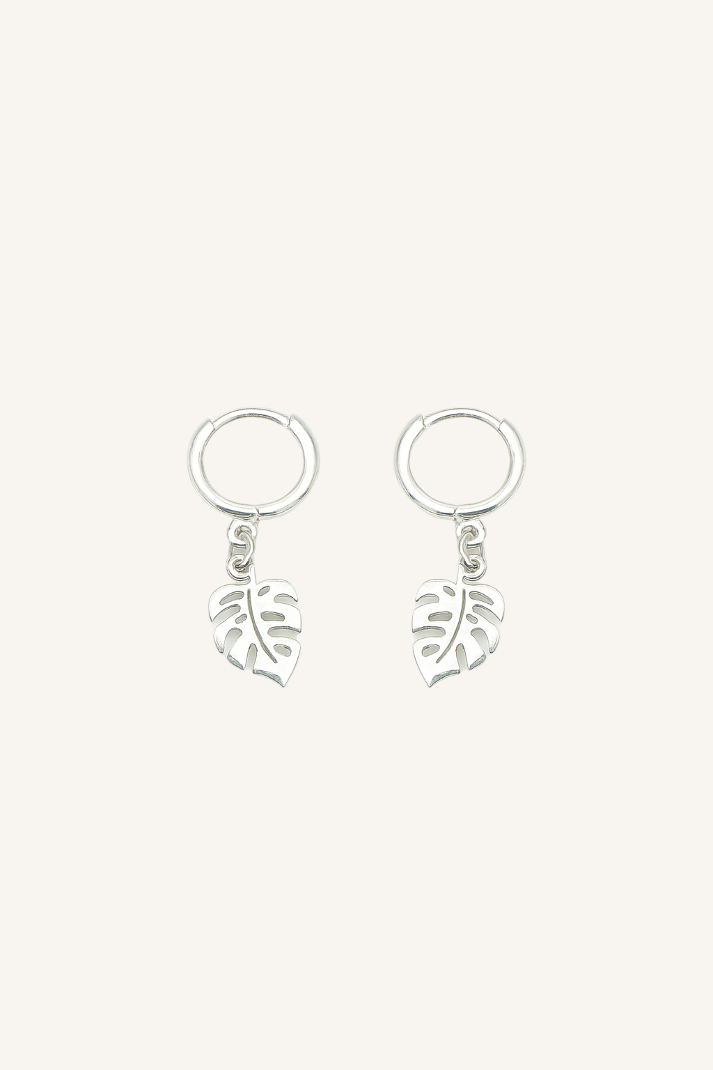 Pair of silver earrings with leaf designs on a white background