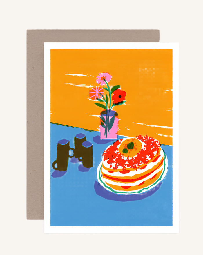 A colorful greeting card featuring a still life illustration with a stack of pancakes, a vase with flowers, and a cup on a table, blank inside.