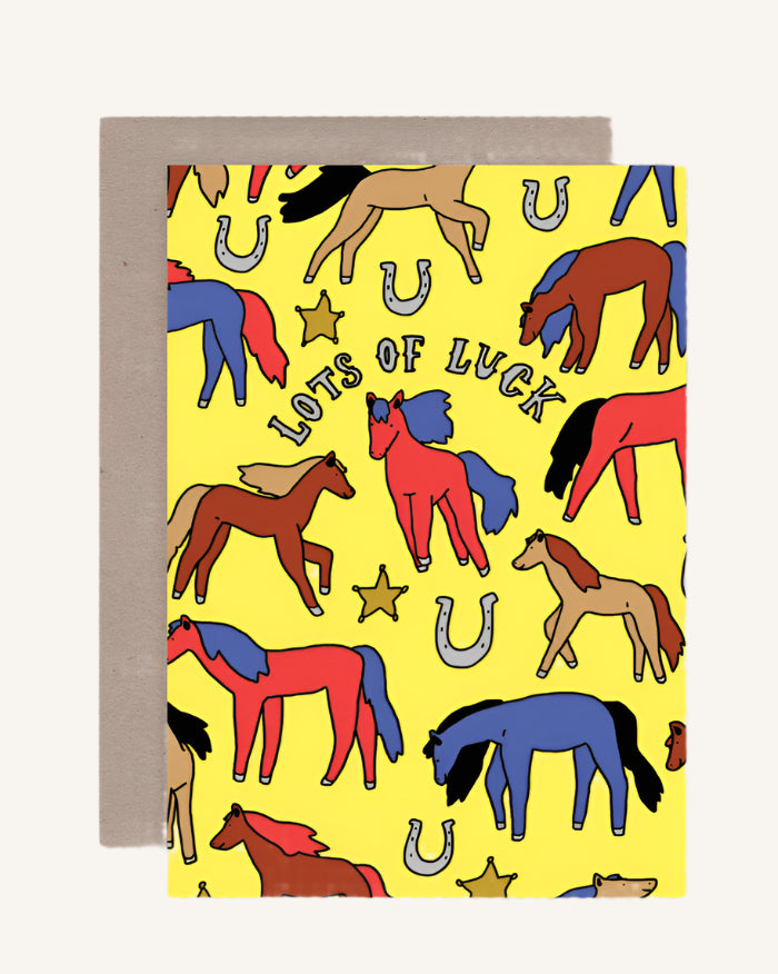 Greeting card with colorful horse illustrations and 'Lots of Luck' text on a yellow background