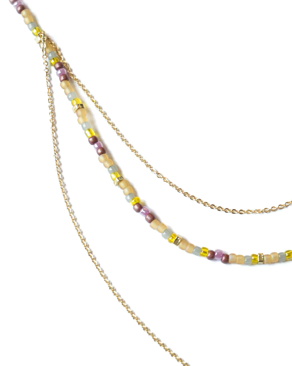 Envet Berry Twist Necklace laid flat on a white background, showcasing pastel glass beads and draped gold-plated chains
