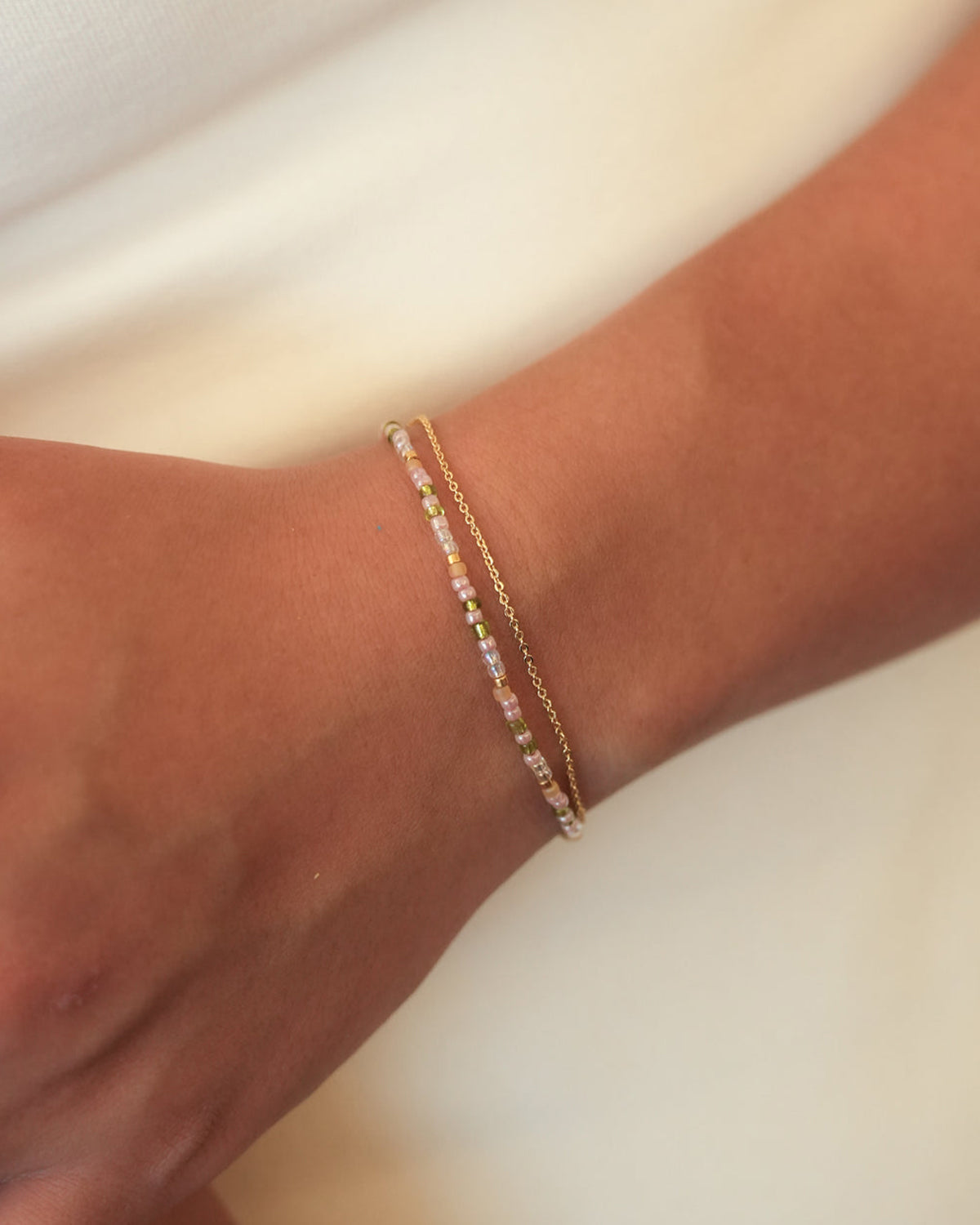 Envet Double Layered Bracelet  featuring pastel-toned glass beads and a gold-plated chain