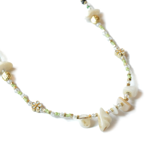 Close-up of Envet Matcha Babe Necklace showing Japanese glass beads, floral accents and natural shells on an 18K gold-plated chain