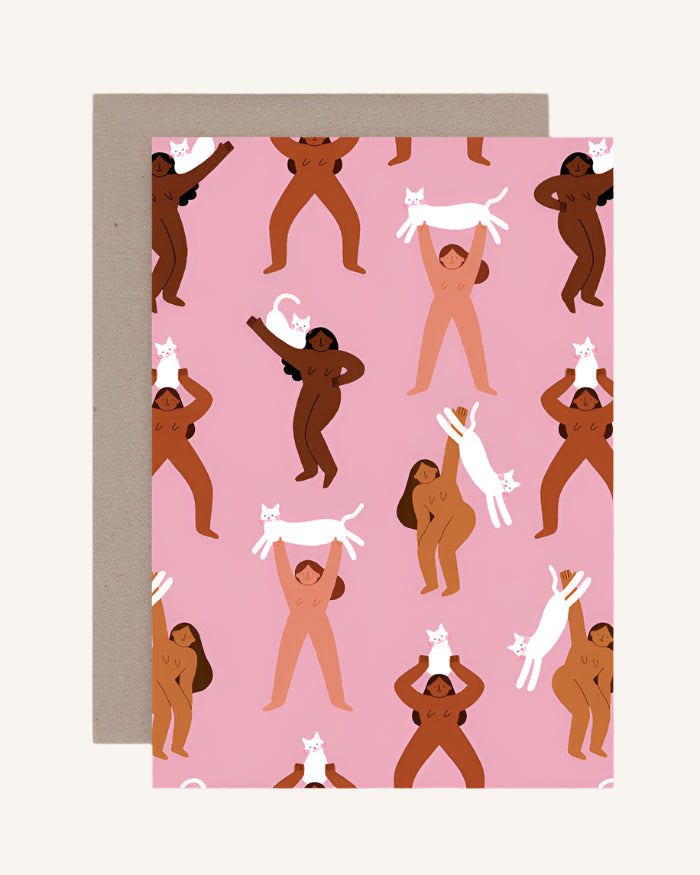 A pink greeting card with illustrations of various cats in different poses, accompanied by a brown envelope.